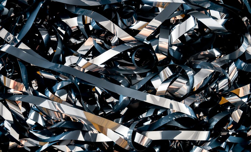 A detailed close-up of tangled magnetic tape ribbons creating a complex abstract pattern.