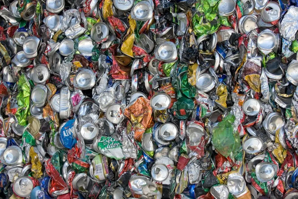 Colorful crushed aluminum cans emphasizing sustainability and recycling.