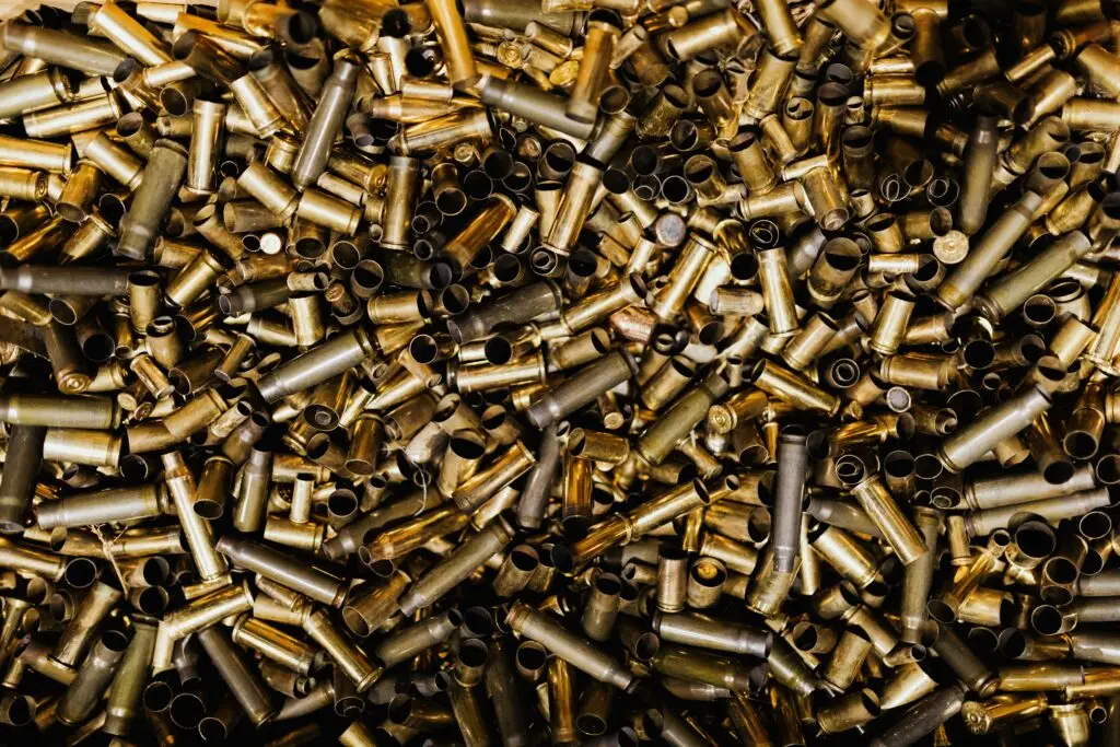 A detailed view of a pile of brass bullet casings, showcasing their metallic luster.
