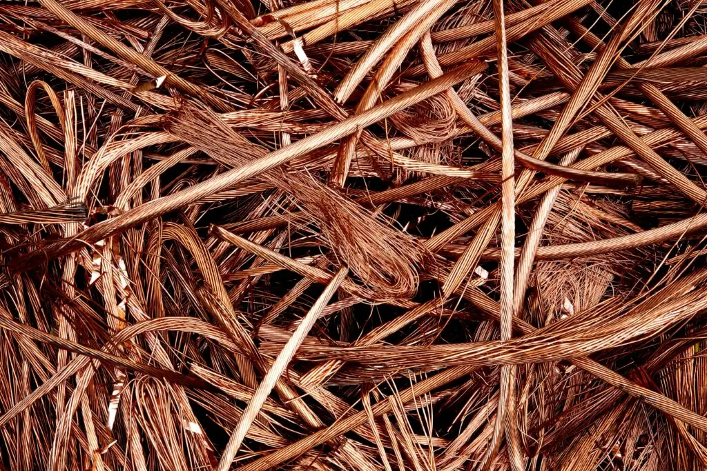 Close-up view of intertwined copper wires ready for recycling, emphasizing industrial reuse.